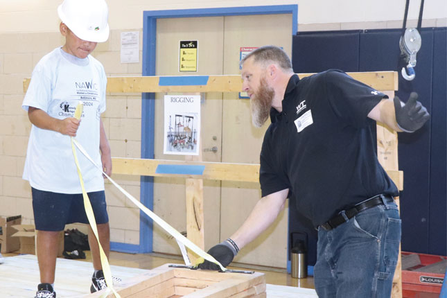 A Whiting-Turner employee assists a Kennedy Krieger student during Block Kids.