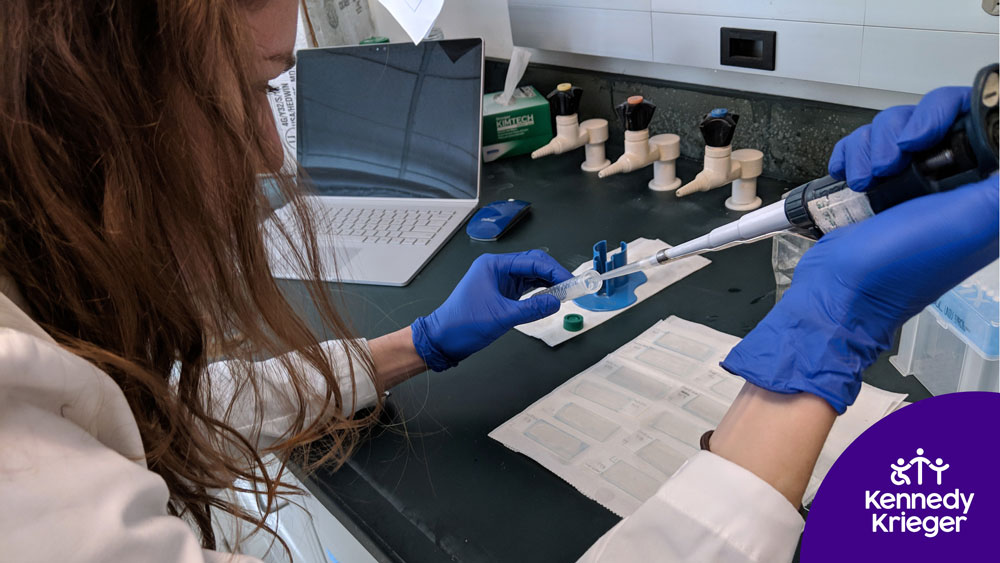 A research investigator works in a lab at Kennedy Krieger Institute.