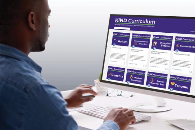 A man looks at the website for the KIND Curriculum.