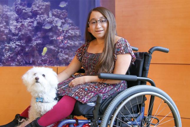 Kennedy Krieger patient Shannon with her service dog, Frosty