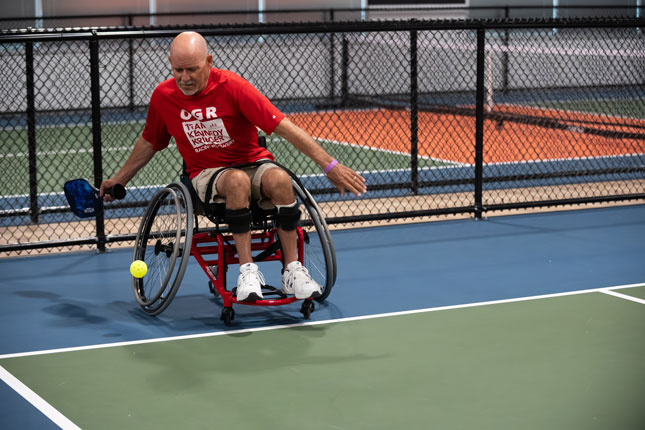 An adaptive sports athlete plays pickleball.