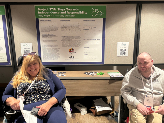 Tracy Wright and Mat Rice sit in front of the poster presentation, "Project STIR: Steps Toward Independence and Responsibility"