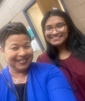 Two women smile in a selfie.