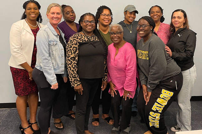 A group of women smile in a photo at Spectrum of Hope.