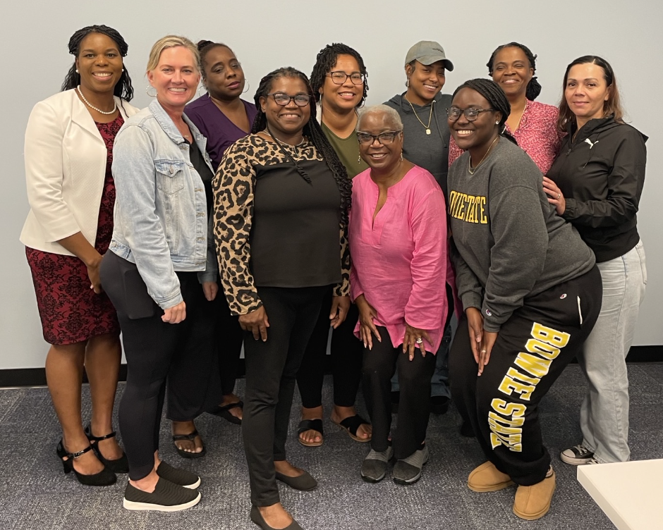 A group of people smile in a photo at the Spectrum of Hope event.