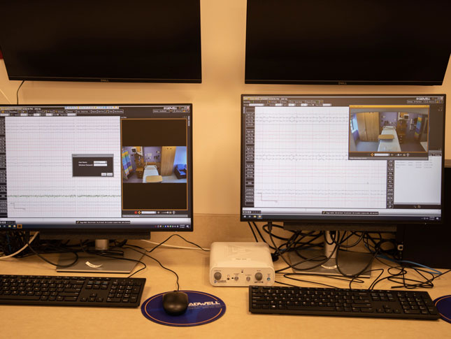 Two computer monitors in the EEG room.
