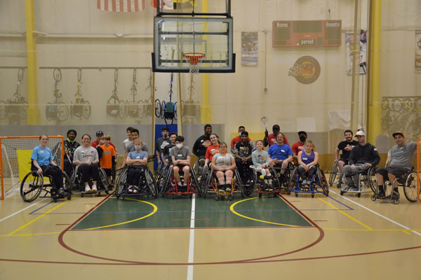 Adaptive sports basketball players pose for a team photo. 