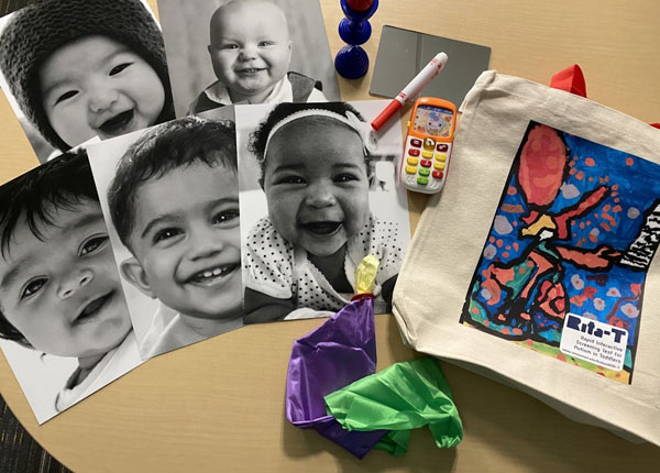 Black and white photos of smiling toddlers on a table with school supplies and a Rita-T canvas bag.