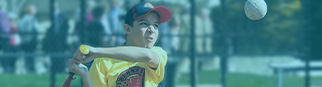 A boy swings at a pitch in an adaptive sports baseball game.
