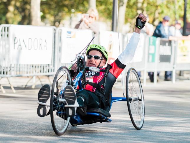 A photo of Jerry, a Kennedy Krieger International Center for Spinal Cord Injury patient, handcycling at the Baltimore Running Festival