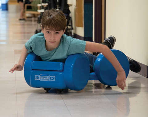 A photo of Brayden mock-surfing down the hall at the Institute's day hospital.