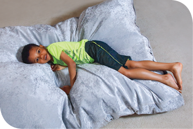 After completing his at-home sensory circuit, Dale rests on a giant “crash pillow."