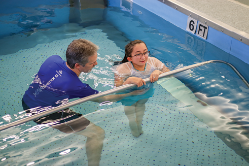 Shannon develops core strength in aquatherapy with physical therapist Christopher Joseph.