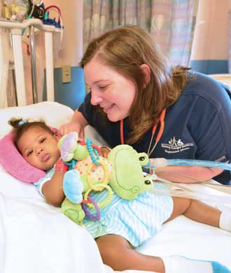 A nurse tends to her patient, a young girl. 