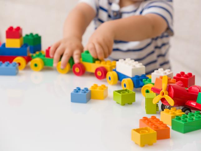 A photo of a young boy playing with Legos