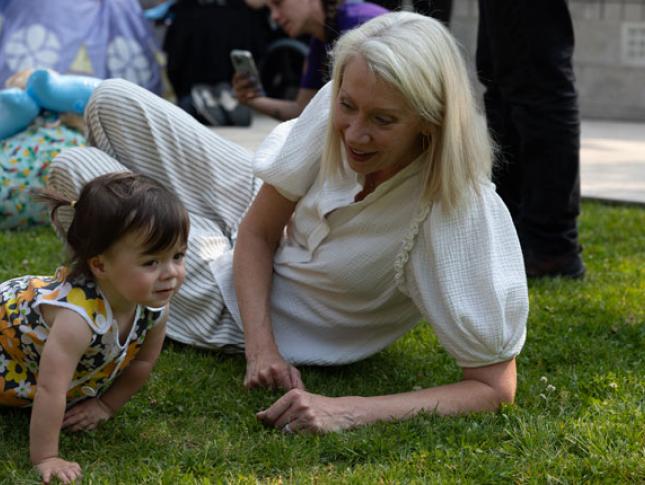 A WIN member interacts with a young child at Kennedy Krieger's Therapy Garden.