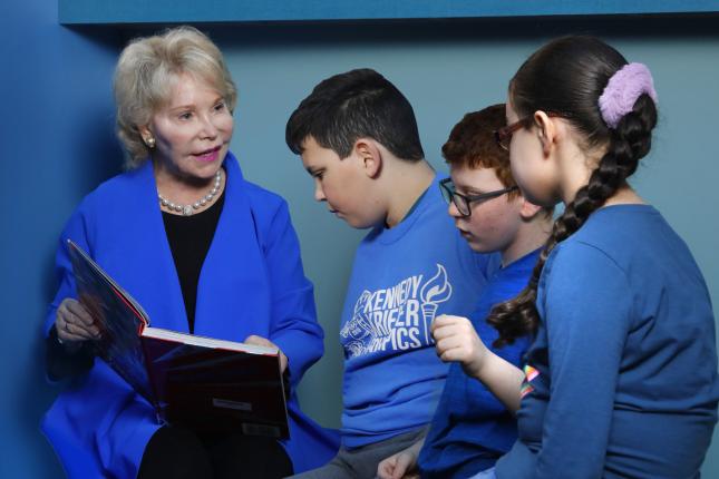 Nancy Grasmick reads a book to a group of children
