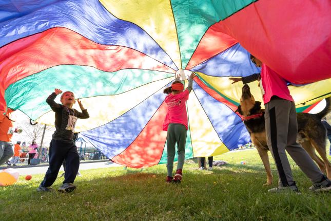 Photo of children at ROAR for Kids playing with a parachute