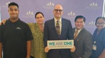 Brad Schlaggar our CEO stands with team members from Kennedy Krieger