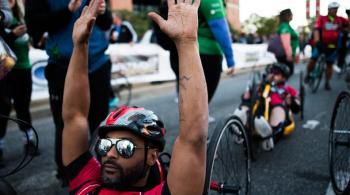 Handcyclists cross the finish line.