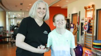 Heather McLean, Kennedy Krieger physical therapist, with Ellie