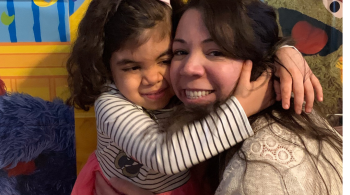 A photo of Violet hugging her mom, Inez