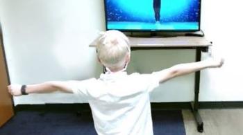 A child uses the Computerized Assessment of Motor Imitation (CAMI) video game tool.